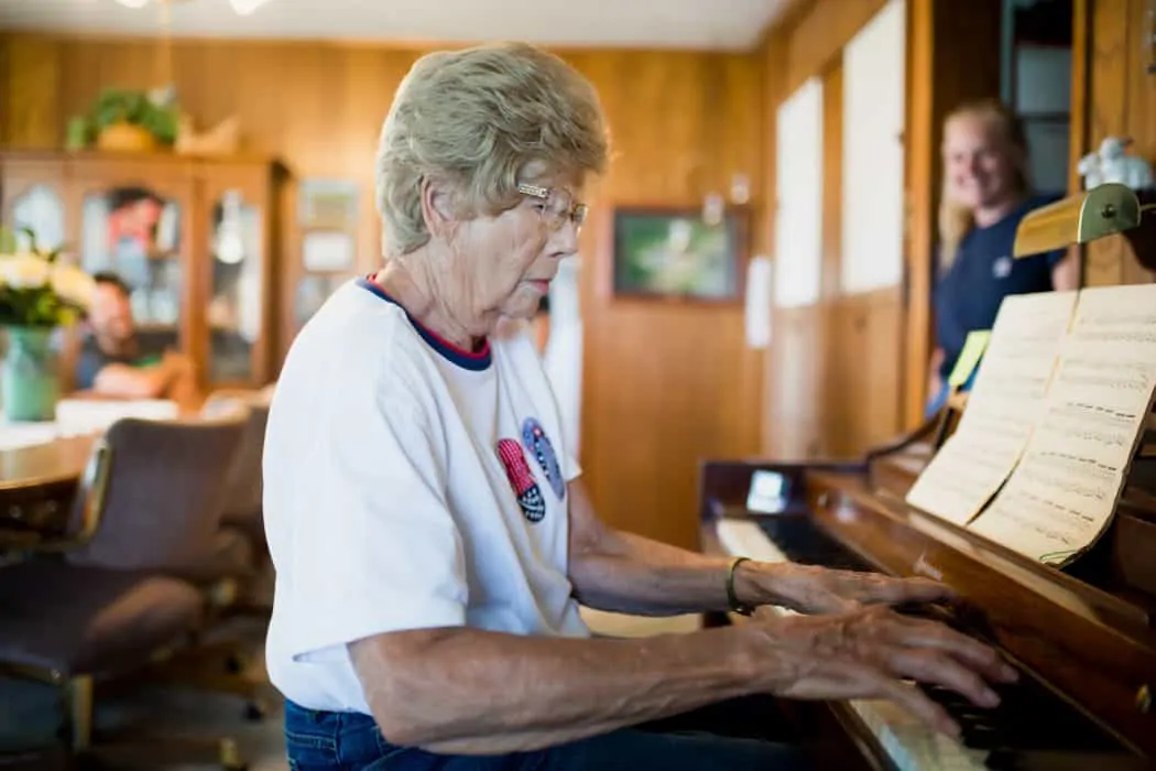 FarmWoman playing the piano in her living room