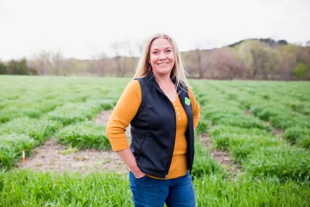 Jami Loecker, Agronomy Manger for Syngenta standing in a field in Kansas. 