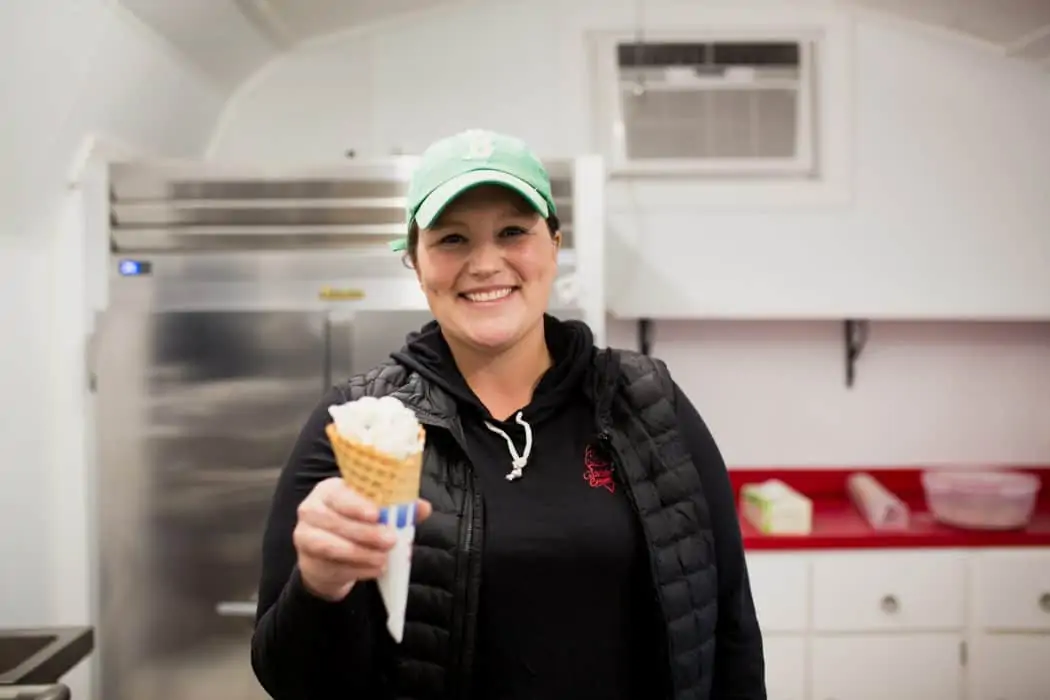 Brooke Gladstone holding an ice cream cone in her ice cream parlor. 